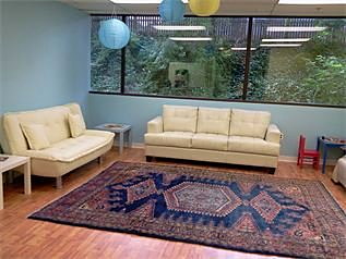 The Natural Pediatrics waiting room with couches, paper lanterns and a toy corner.